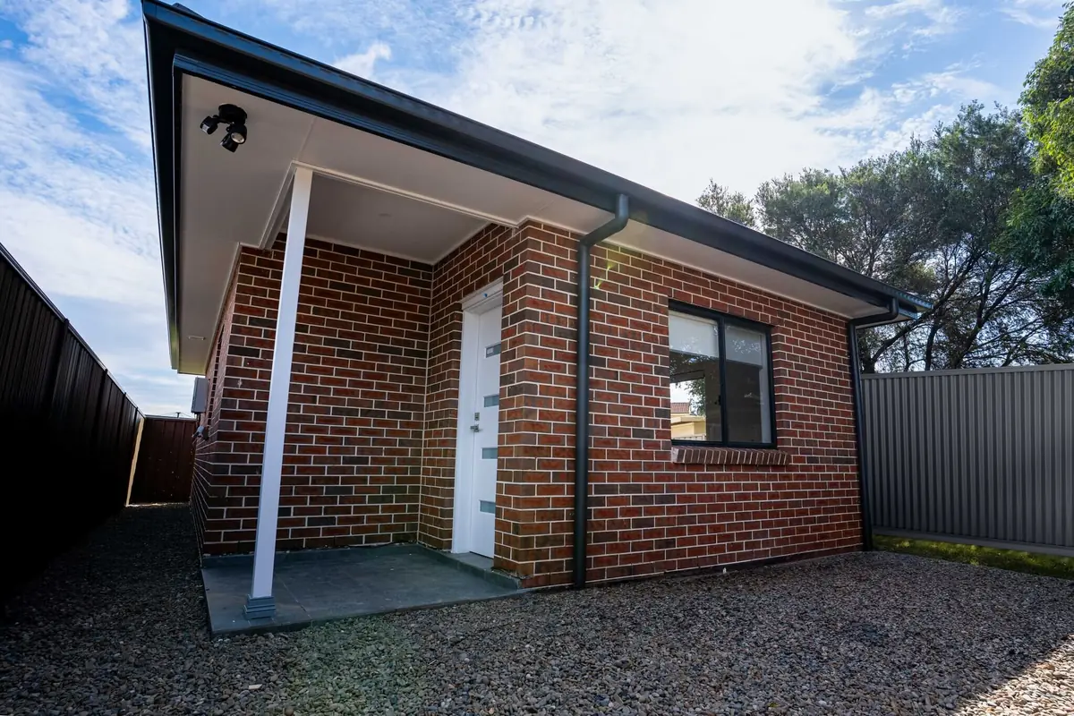 A completed red brick granny flat with covered entry